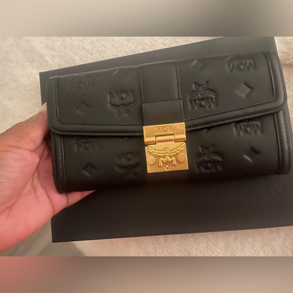 MCM Black Clutch with Gold Lock
NEW!! 
Never worn
Includes a shopping bag
